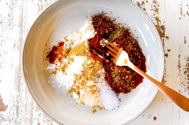 showing how to make enchilada sauce by combining flour, chili powder, dried oregano, cumin, garlic powder, onion powder and smoked paprika
