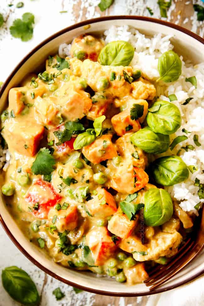 top view of showing how to make Thai Green Curry recipe by adding to rice and garnishing with cilantro