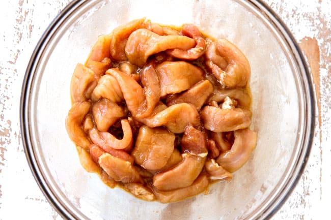 showing how to make hot and sour soup recipe by whisking soy sauce, cornstarch and sesame oil together in a medium bowl and tossing with pork.