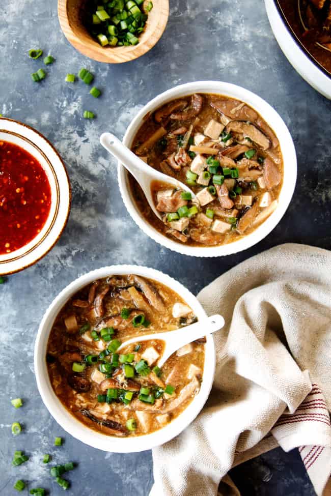 top view of two bowls of authentic Hot and Sour Soup recipe garnished with green onions