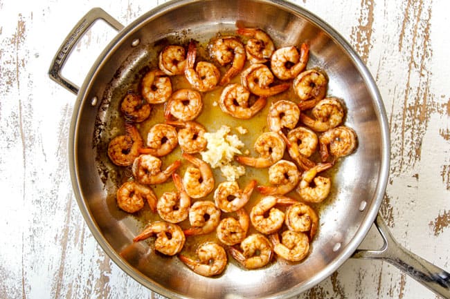 showing how to make Lemon Garlic Shrimp by adding lemon juice and garlic to the shrimp in a skillet