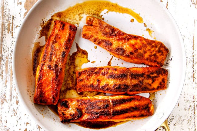 showing how to make lemon salmon and asparagus by cooking salmon in butter