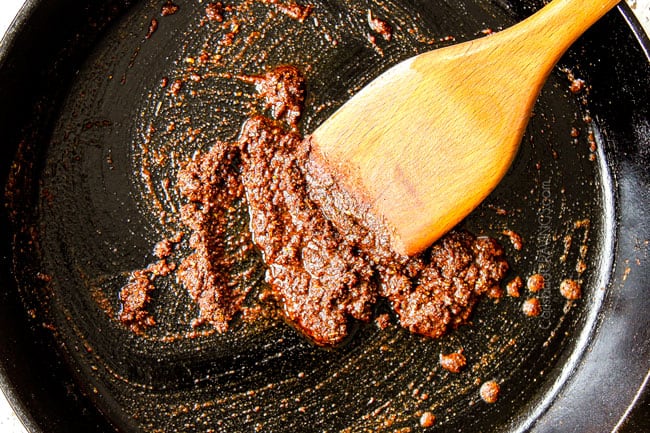 showing how to make chicken tostadas by blooming spices in a cast iron skillet