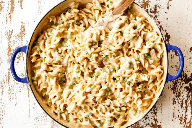 showing how to make Tuna Noodle Casserole by stirring noodles into sauce