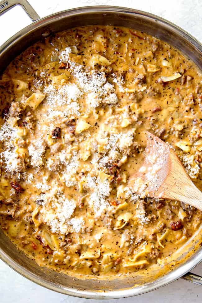 showing how to cook linguine noodles by stirring in Parmesan cheese