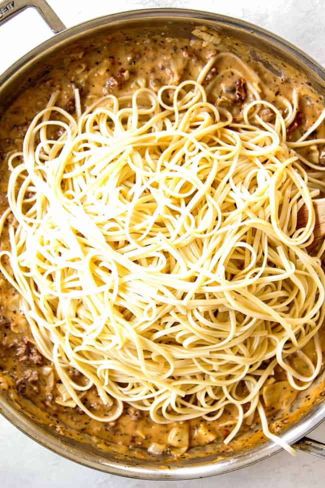showing how to make linguine noodles by stirring noodles into sauce