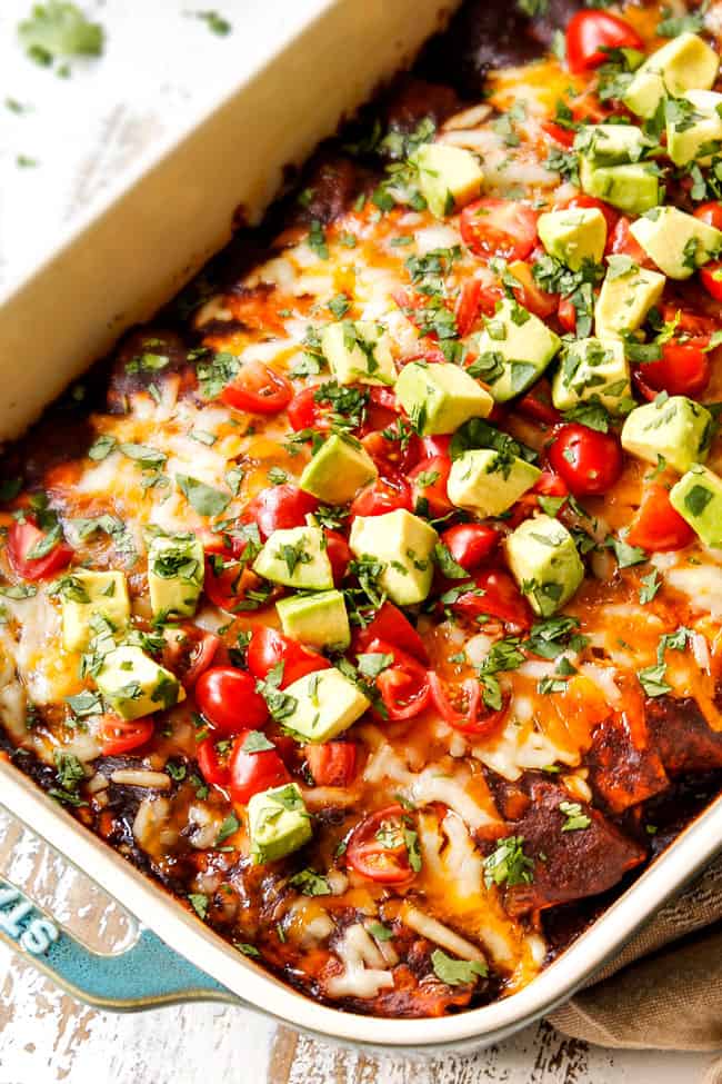 showing how to make ground beef enchiladas by topping with enchilada sauce and cheese