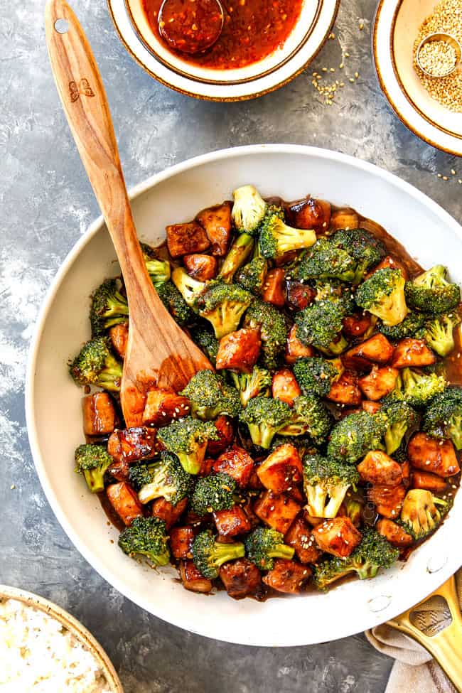 showing how to make Chicken and Broccoli stir fry with a top view of the sauce in the skillet simmering until thickened
