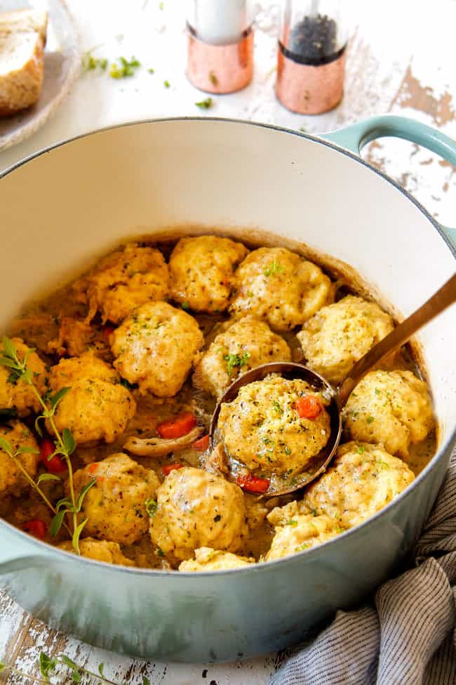 showing how to serve easy chicken and dumplings recipe by scooping up some dumplings with the soup