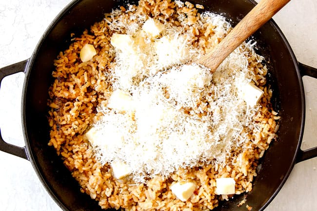 showing how to make mushroom risotto recipe by stirring Parmesan and butter