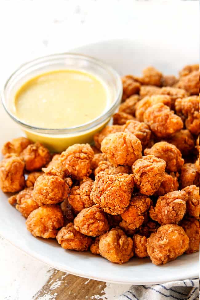 showing how crispy KFC Popcorn Chicken is lining on a platter