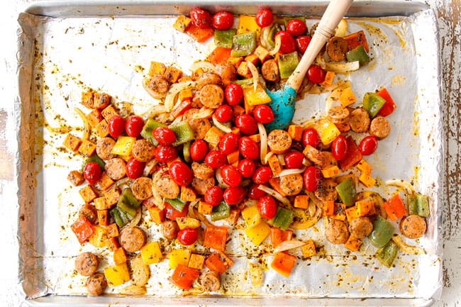 showing how to make Italian Sausage and Peppers by mixing tomatoes into sausage and peppers