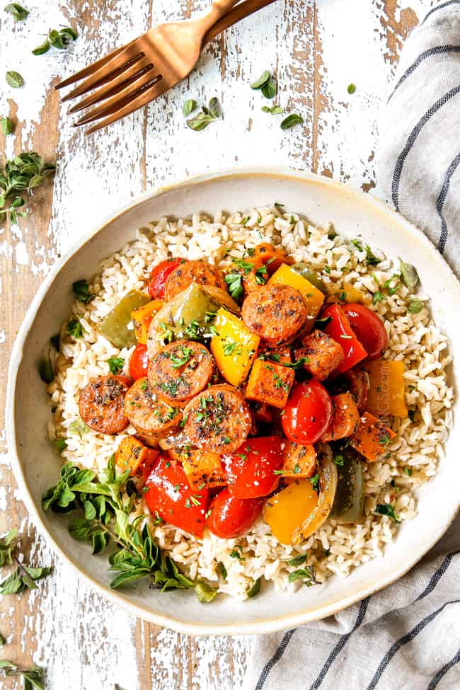 showing how to serve Sausage, Peppers and Onions by adding to a bowl of rice