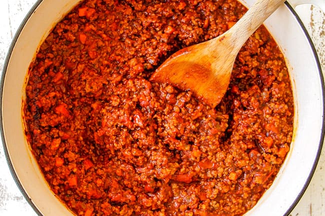 showing how to make easy Baked Ziti with meat by simmering sauce until reduced