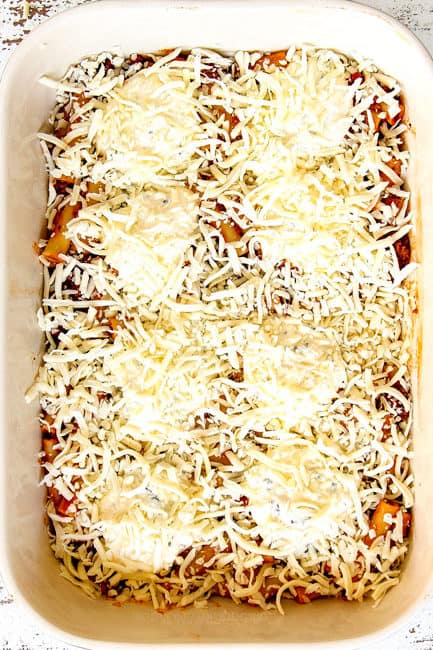 showing how to make Baked Ziti by recipe topping ziti with mozzarella