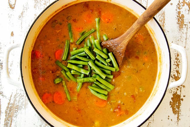 showing how to make chicken stew recipe by simmering soup until thickened then adding green beans