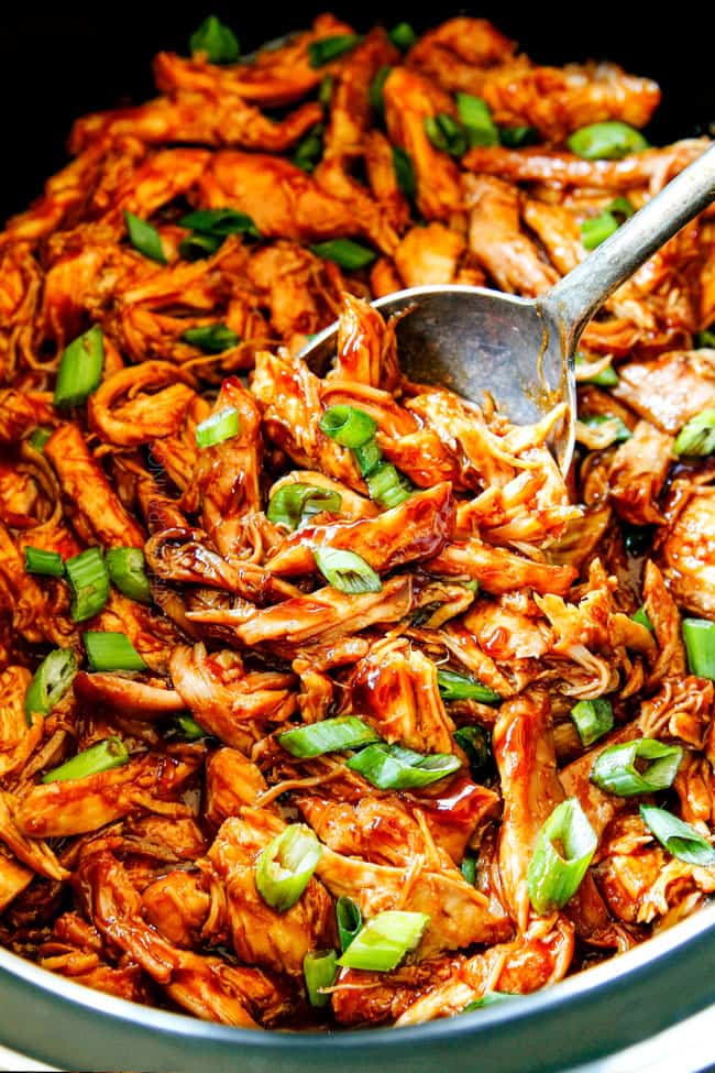 showing how to garnish slow cooker honey garlic chicken recipe by topping chicken with green onions