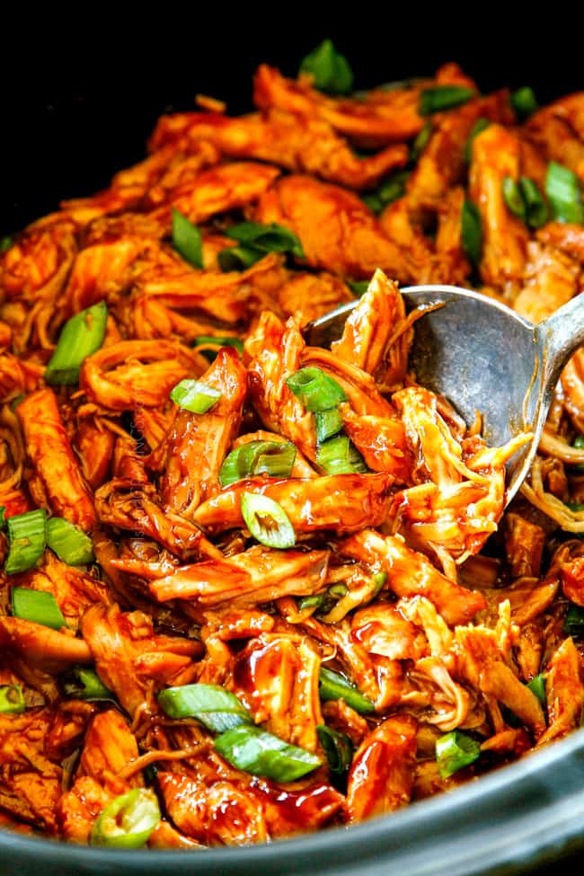 up close of a spooning honey garlic chicken showing how saucy the chicken is