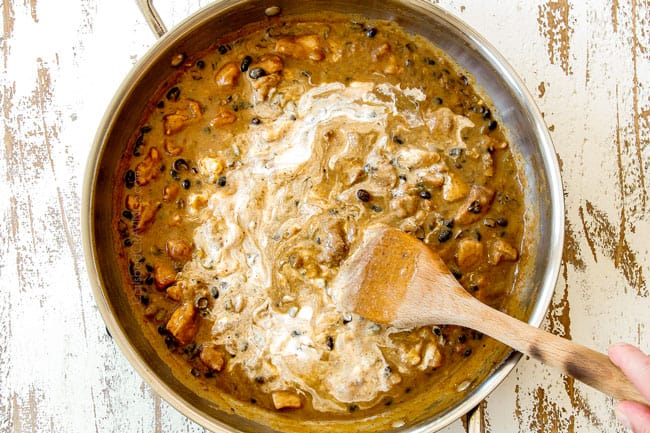showing how to make Green Chili Chicken by stirring sour cream into green chili sauce in stainless steel skillet until smooth