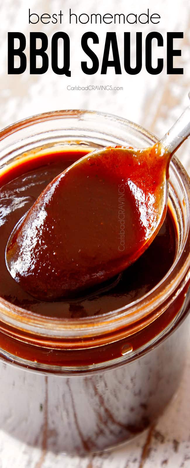 showing how thick and rich BBQ Sauce recipe is by dipping a spoon into a mason jar of sauce