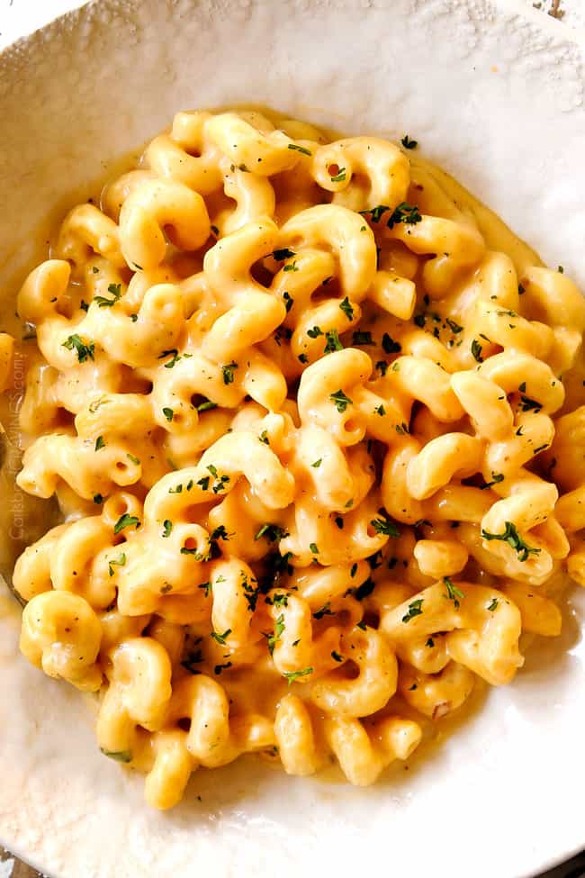 showing how to serve stovetop homemade mac and cheese by adding to a white bowl