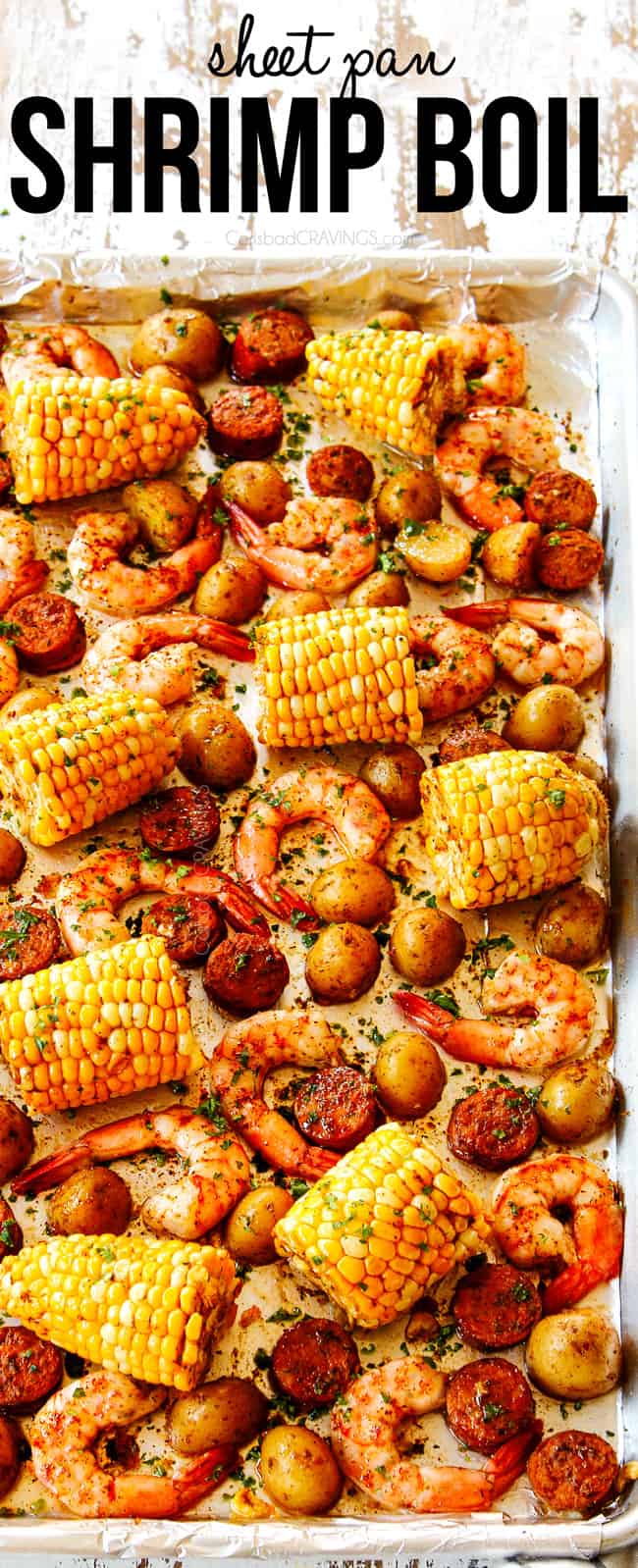 showing how to make shrimp boil recipe by drizzling cooked shrimp, potatoes,  corn and  sausage with lemon juice and  butter