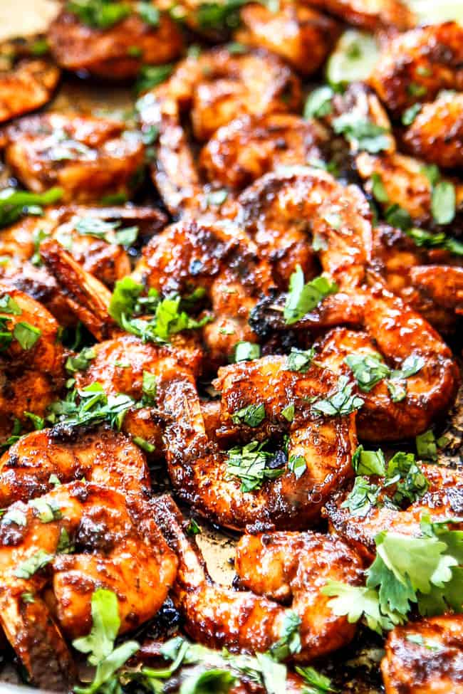 showing how to garnish jerk shrimp by tossing with parsley