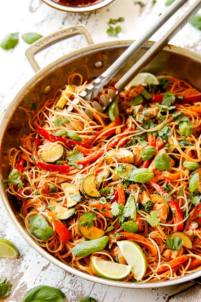 side view of rice noodles recipe in a skillet showing how to make by tossing rice noodles with stir fry sauce
