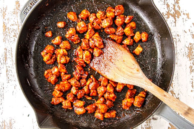 showing how to make BBQ Chicken Pizza recipe by tossing in BBQ sauce