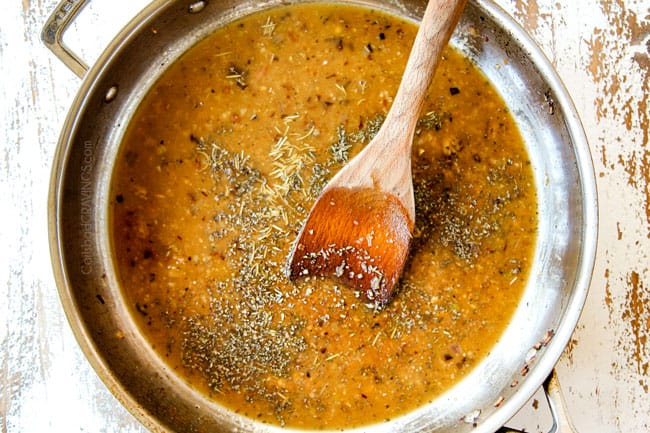 showing how to make mushroom pasta by simmering chicken broth with rosemary, thyme and basil in a stainless steel skillet