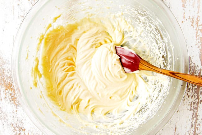showing how to make Strawberry Shortcake by whipping cream in a glass bowl