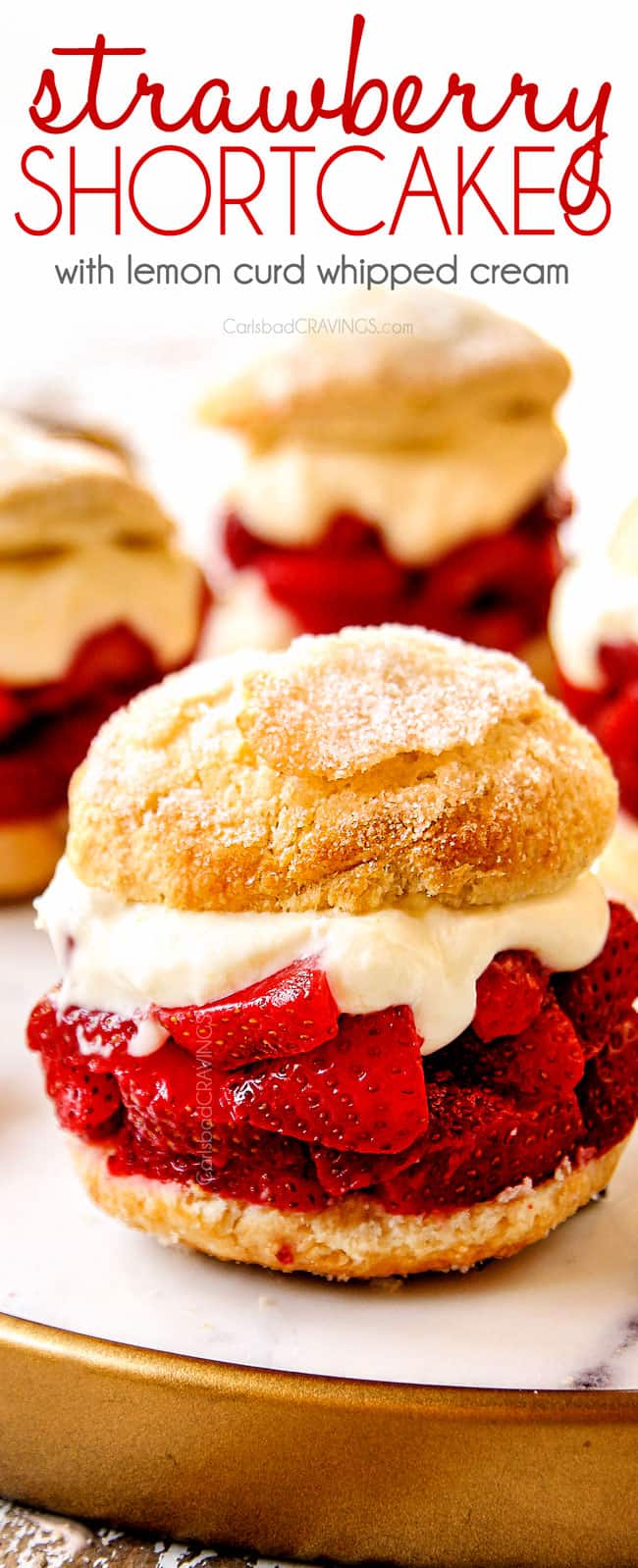 showing how layer strawberry shortcake recipe by layering biscuits with strawberries, whipped cream and a golden biscuit