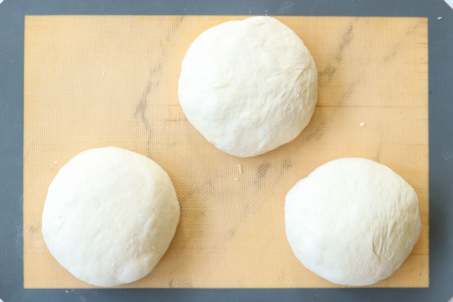showing how to make homemade pizza dough by dividing into three balls
