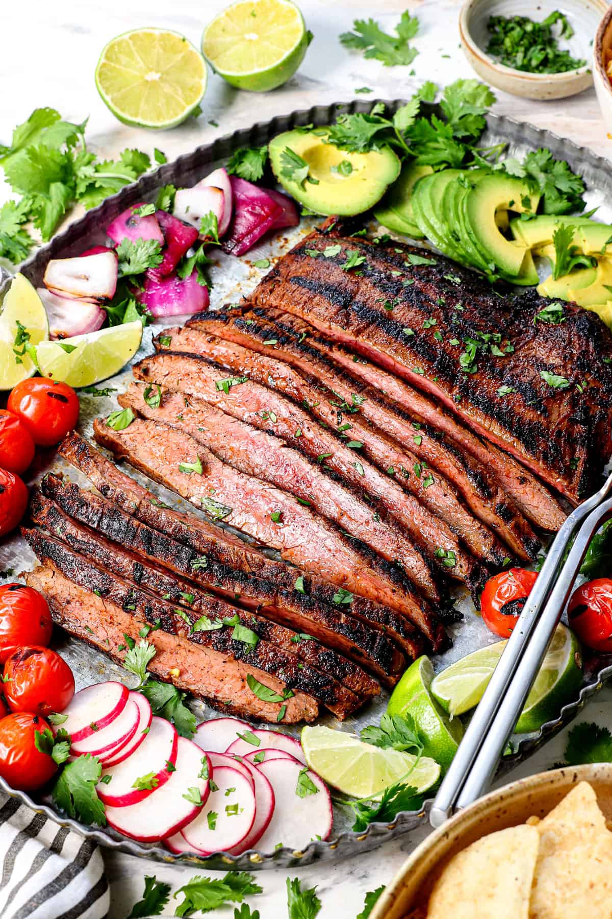 carne asada recipe on a platter with garnishes and rice
