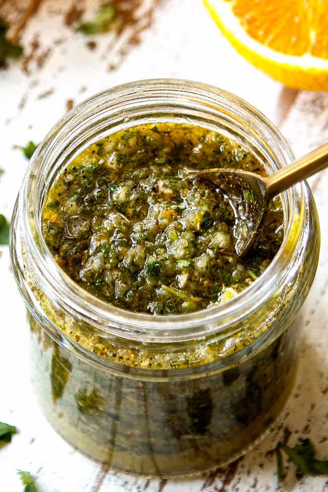 showing how to store mojo marinade by adding to a glass jar.