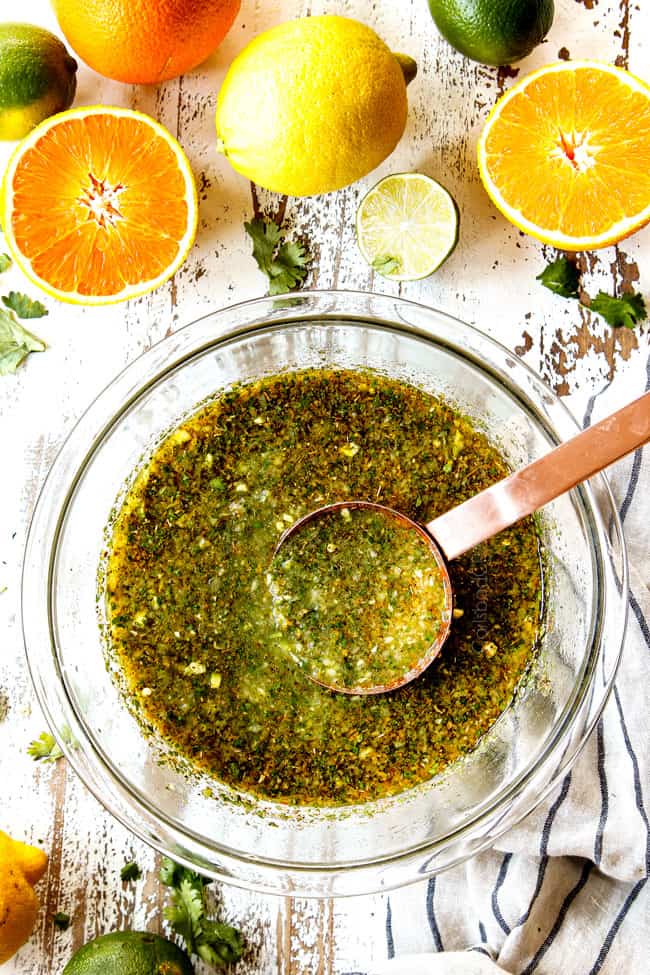 top view of making mojo marinade by combining ingredients in a glass bowl