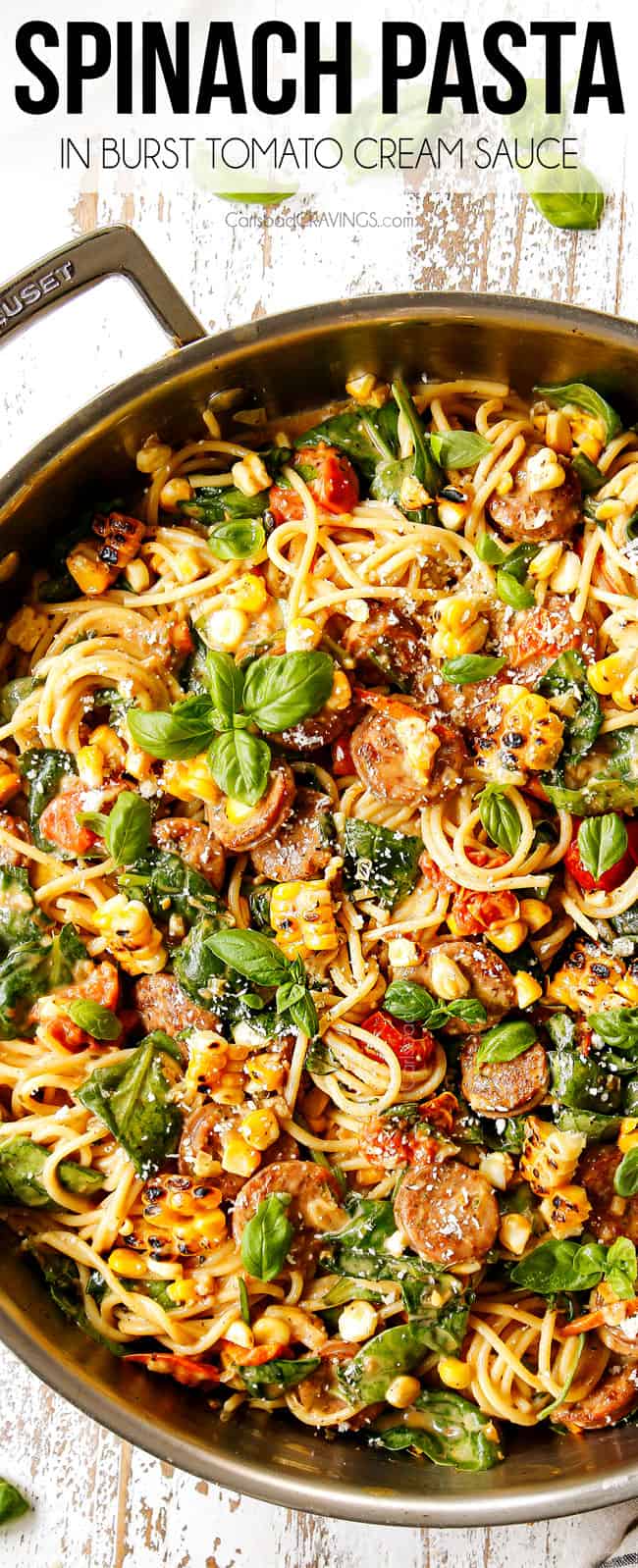 top view of creamy spinach pasta with spaghetti in a stainless steal skillet