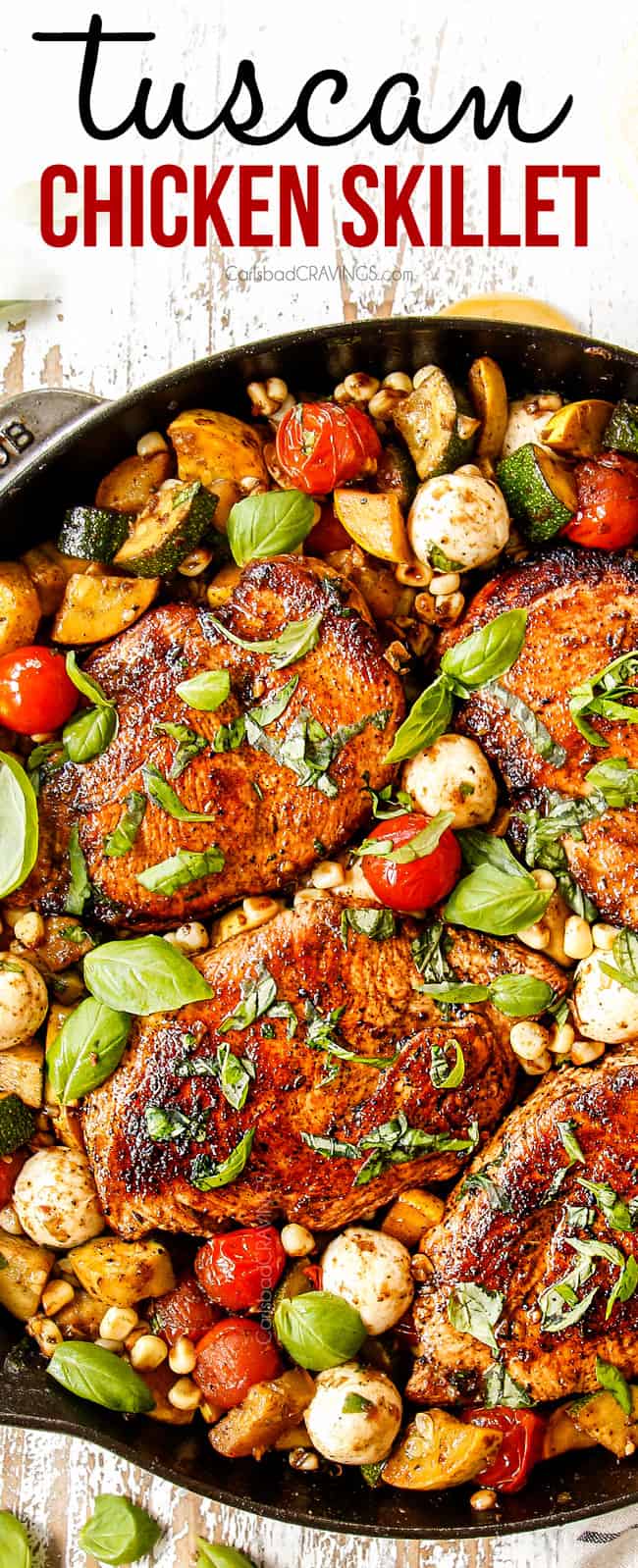 showing how to garnish Tuscan Chicken recipe by adding fresh basil to the skillet