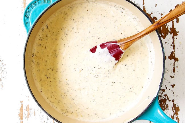 showing how to make zucchini casserole recipe by making cream sauce with heavy cream, parsley, basil and oregano