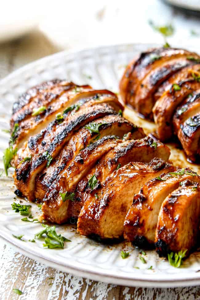 side view of marinated balsamic chicken sliced on a plate