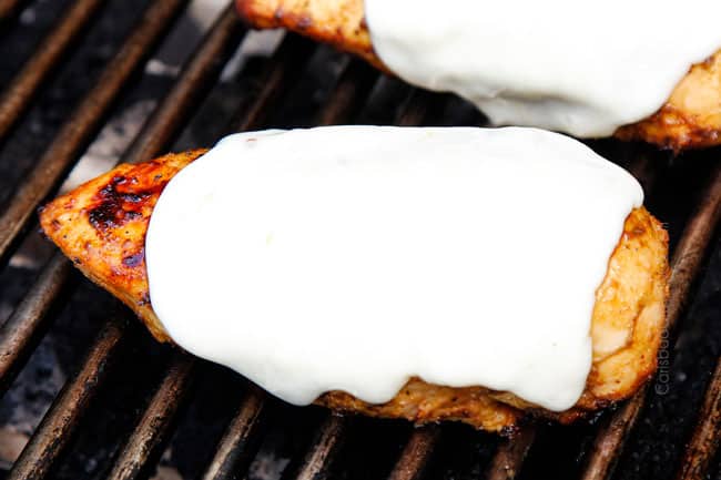 showing how to make Bruschetta Chicken recipe by adding mozzarella cheese and letting it melt