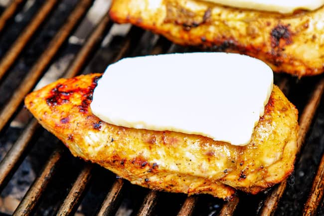 showing how to make Bruschetta Chicken by cooking chicken on the grill