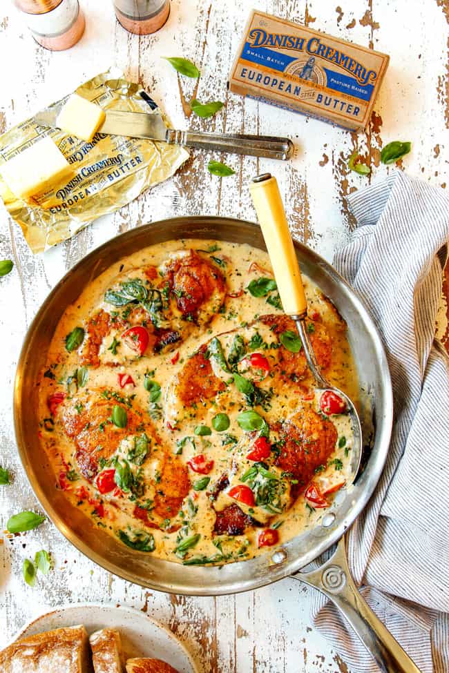 top view of Chicken Florentine in a stainless steel pan showing how to garnish with basil and parsley