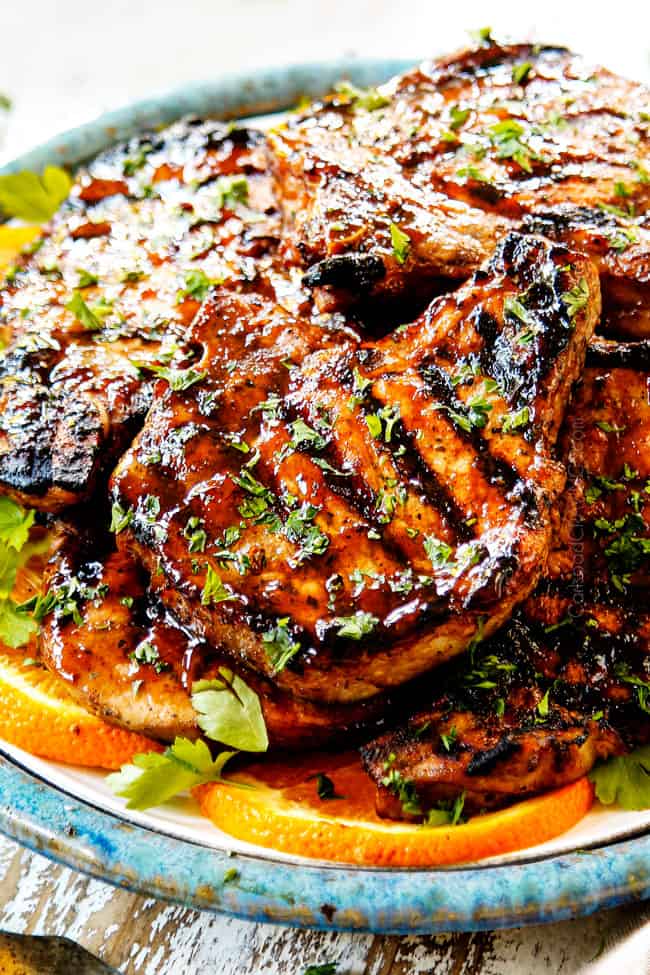 up close of pork chops on a plate that have been marinated in best pork chop marinade