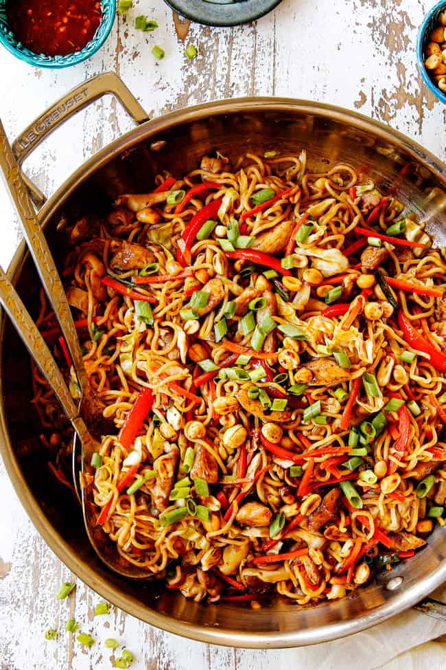 showing how to make chicken yakisoba by tossing chicken and sauce with yakisoba noodles
