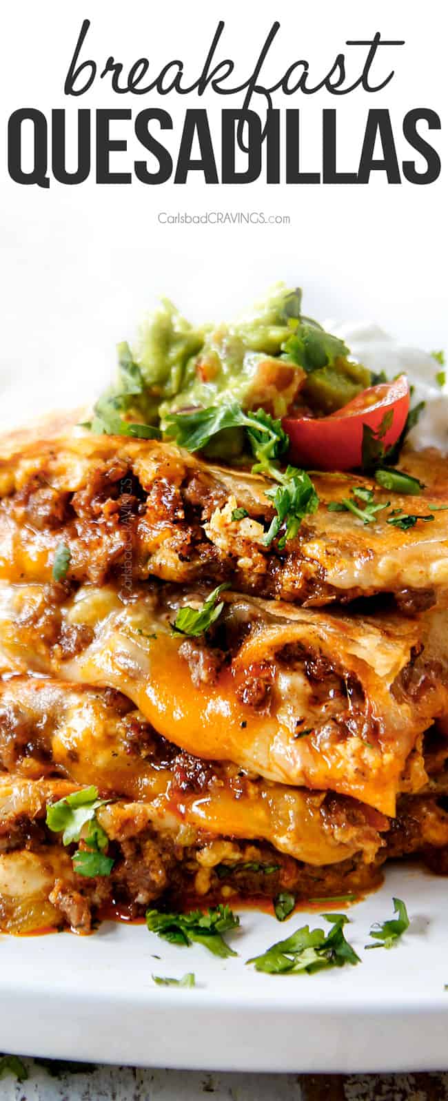 up close of breakfast quesadillas stacked on top of each other with sausage and cheese
