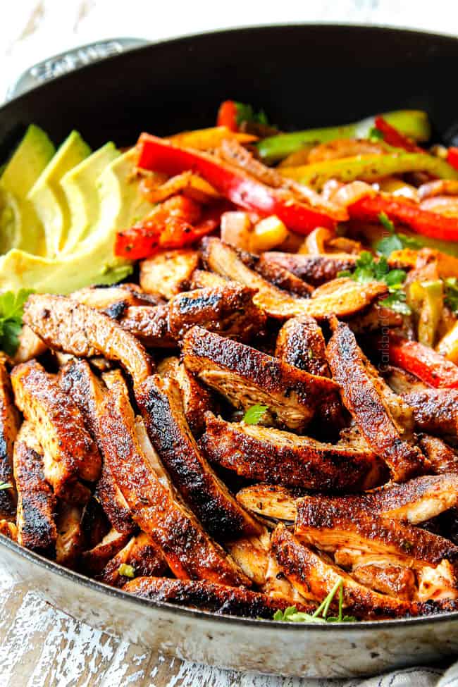serving best chicken fajitas with sliced seared chicken, bell peppers, and onions in a skillet