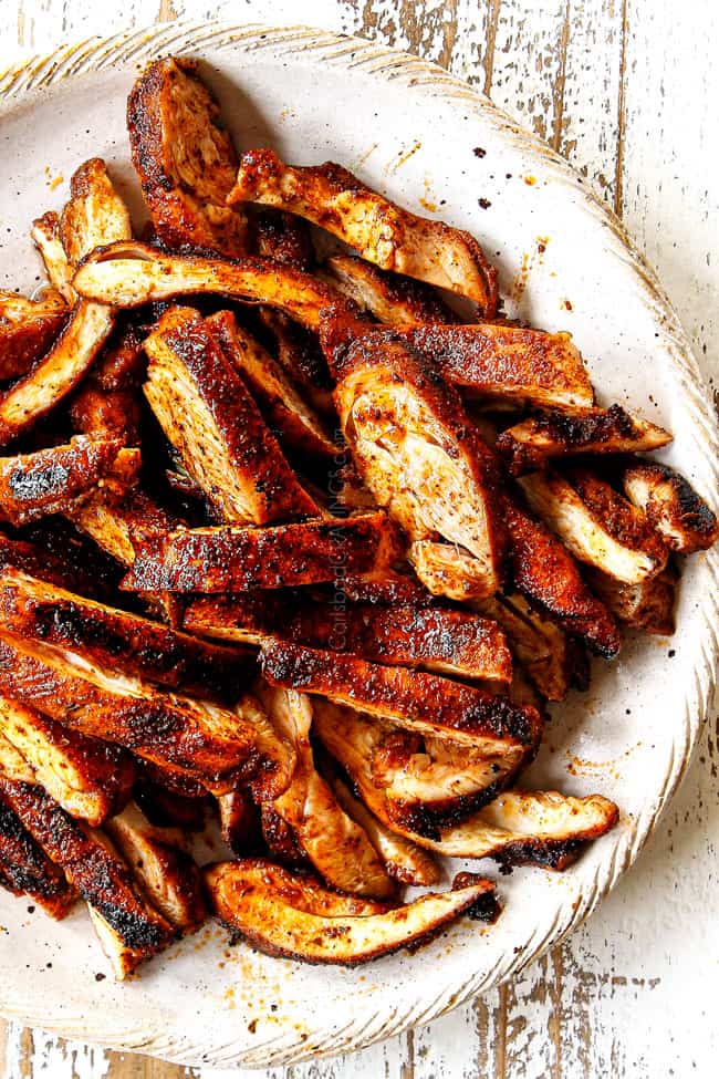 showing how to make chicken fajitas by slicing chicken into thin strips