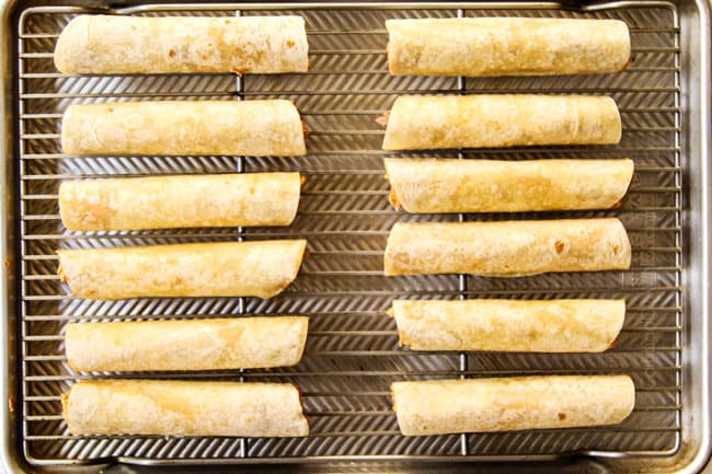 showing how to make flautas by lining flautas on a baking rack in a baking sheet