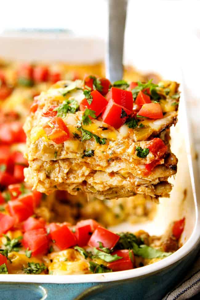 up close of a slice of King Ranch Casserole recipe being lifted out of the pan